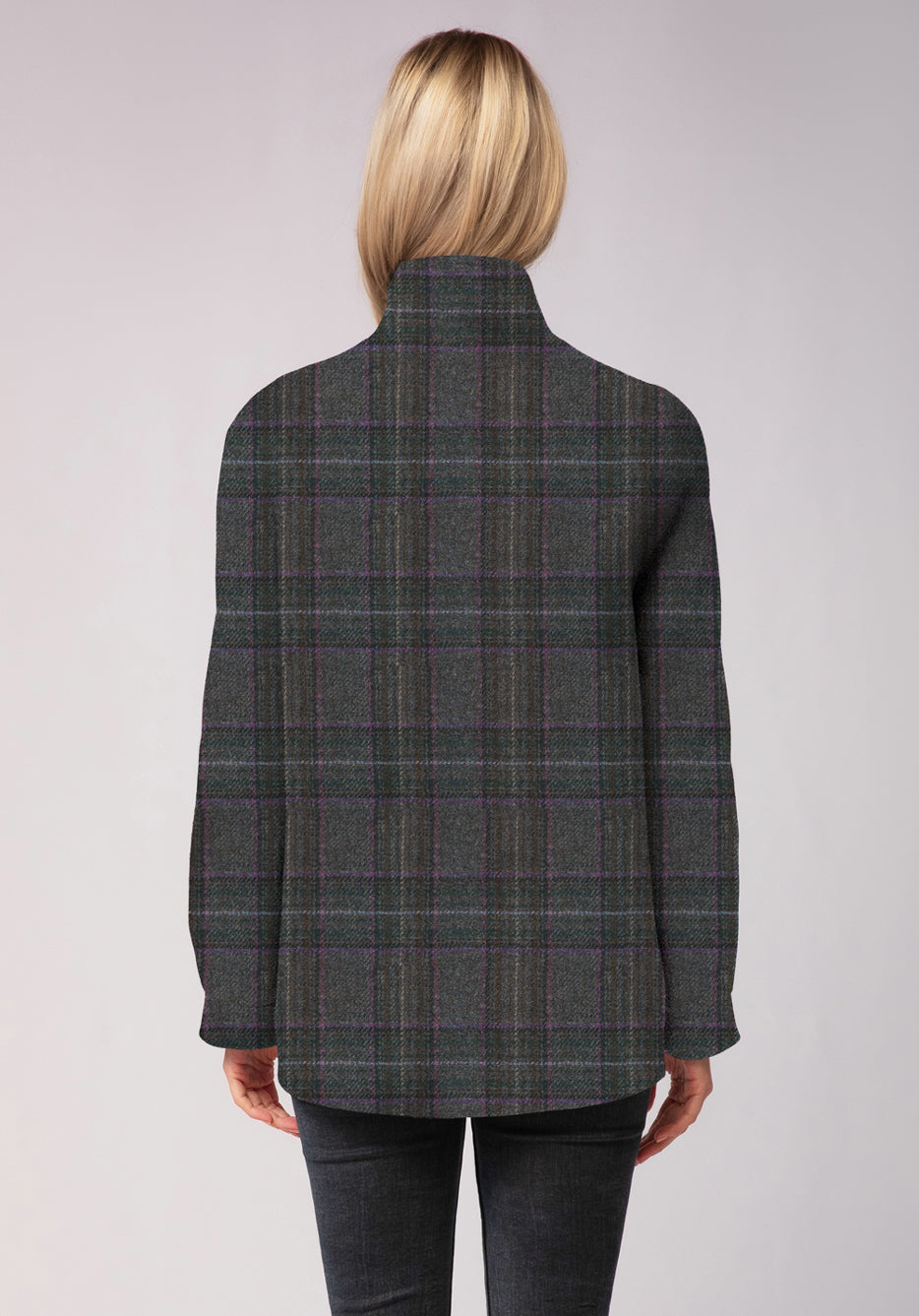 Person wearing a purple and gray plaid jacket on a light gray background