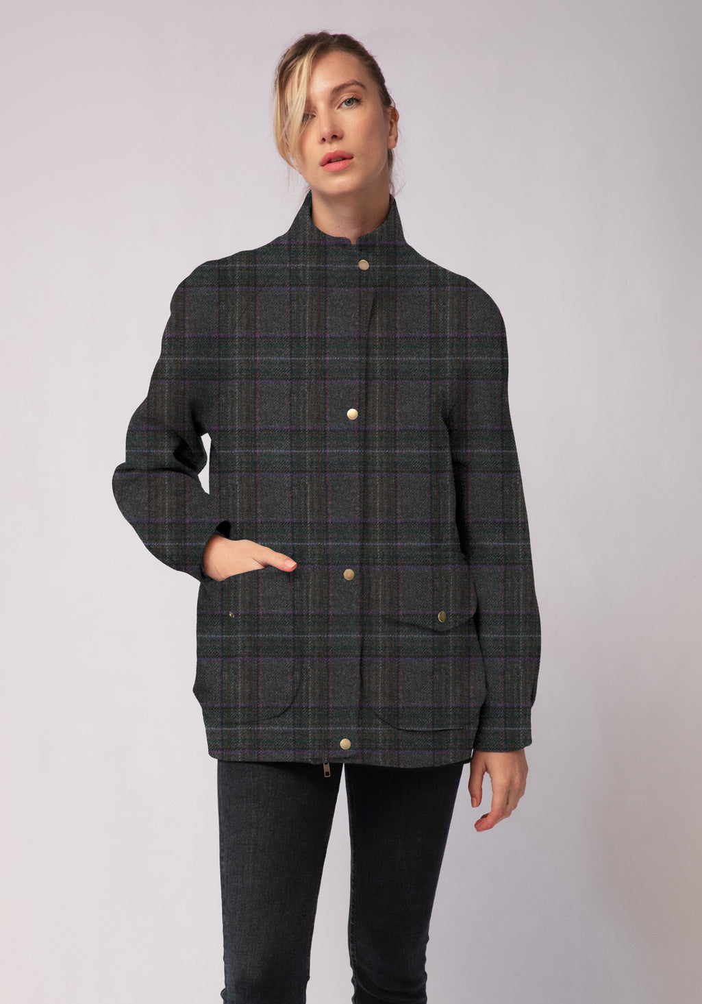Person wearing a dark plaid jacket on a white background