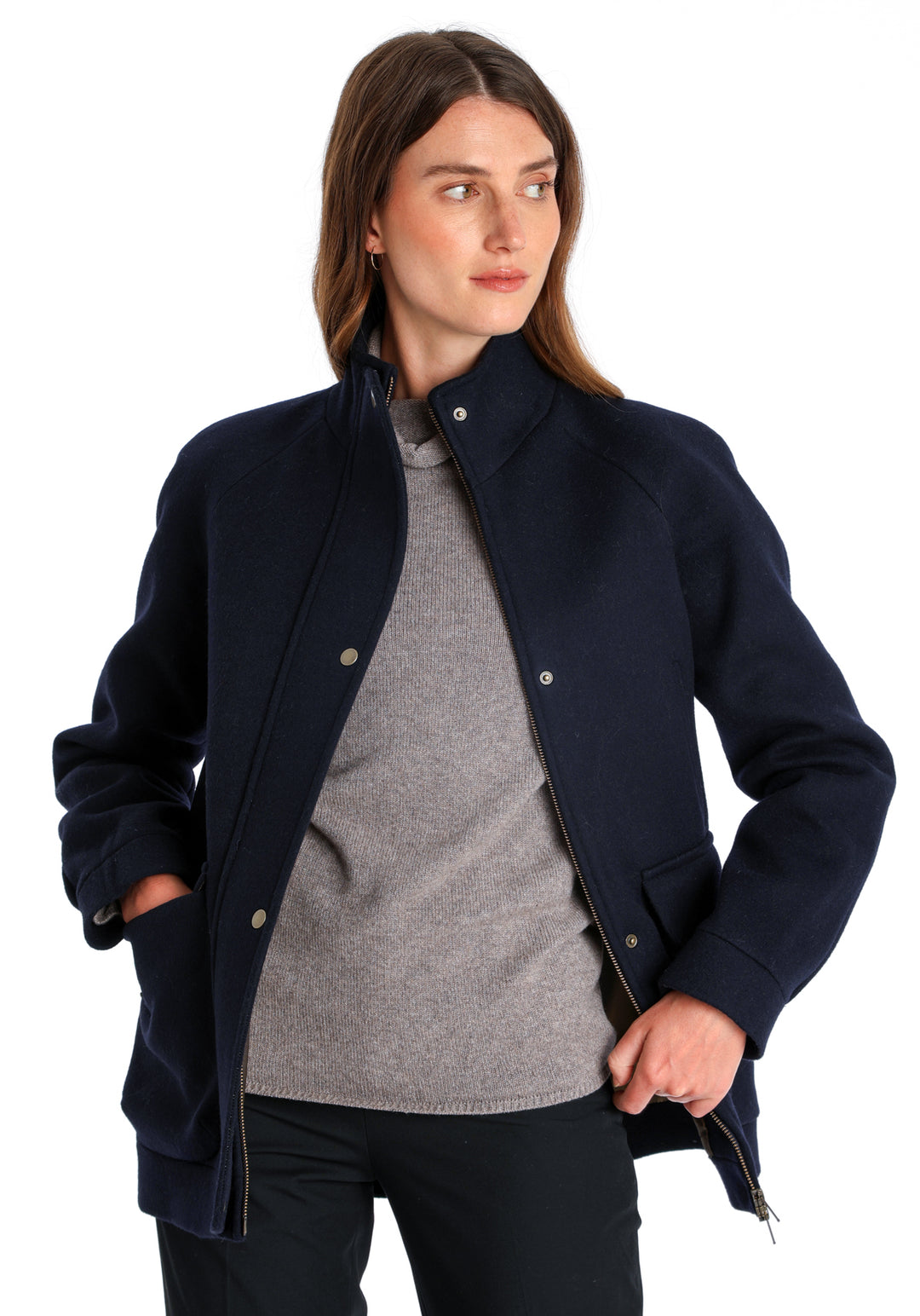 Model wearing the Andrea jacket in navy and rust thick merino wool, a heritage-inspired style with relaxed raglan sleeves, a high neck, and generous pockets, finished with antique brass hardware.