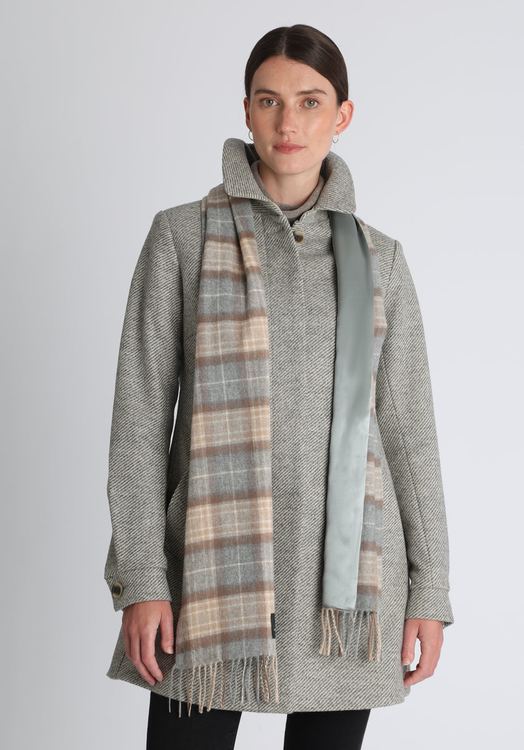 Model wearing the natural check cashmere scarf backed with silver blue silk, over the Cape coat in grey angle stripe.