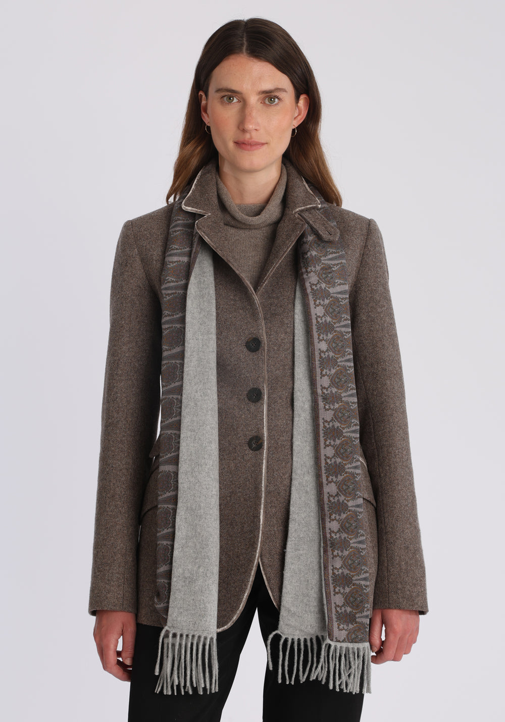 Model wearing the light grey scarf backed with heather paisley printed silk, over the Cass jacket in mallow taupe herringbone.