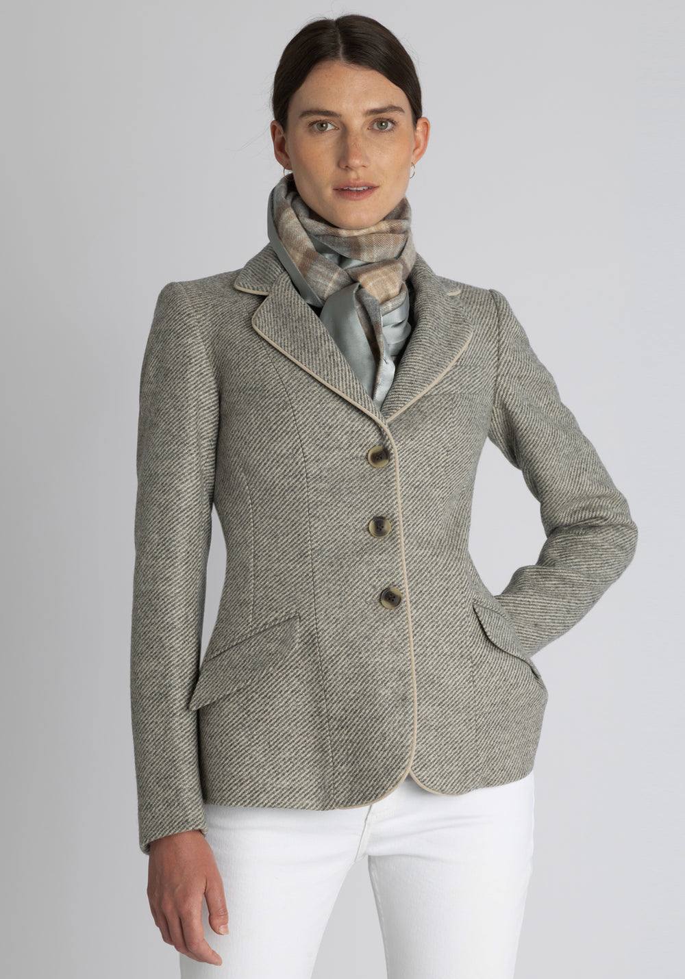 Model wearing the natural check cashmere scarf backed with silver blue silk, over the Hacking jacket in grey angle stripe.