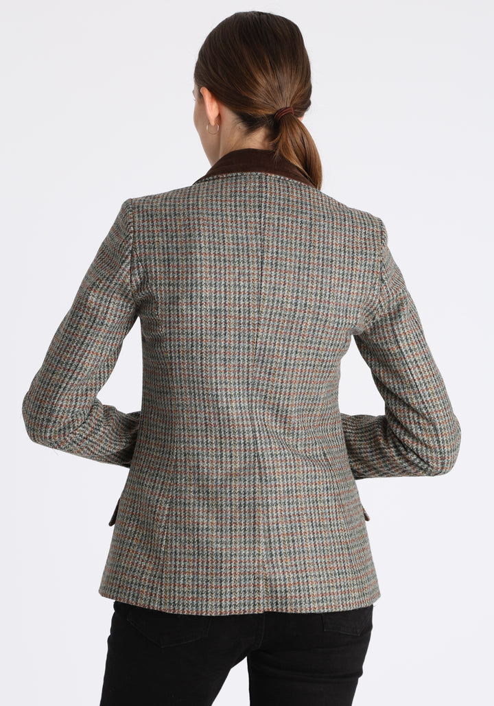 Model wearing the Hacking jacket in an autumnal cinder check wool, a slim fit style with notched lapels, angled hip pockets, and a single back vent, inspired by traditional equestrian tailoring.
