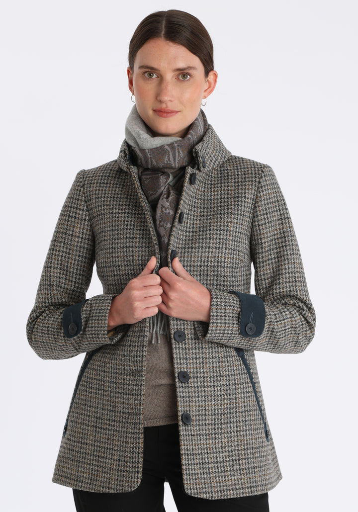 Model wearing the light grey scarf backed with heather paisley printed silk, with the Hendre jacket in stone and ochre dogtooth check.