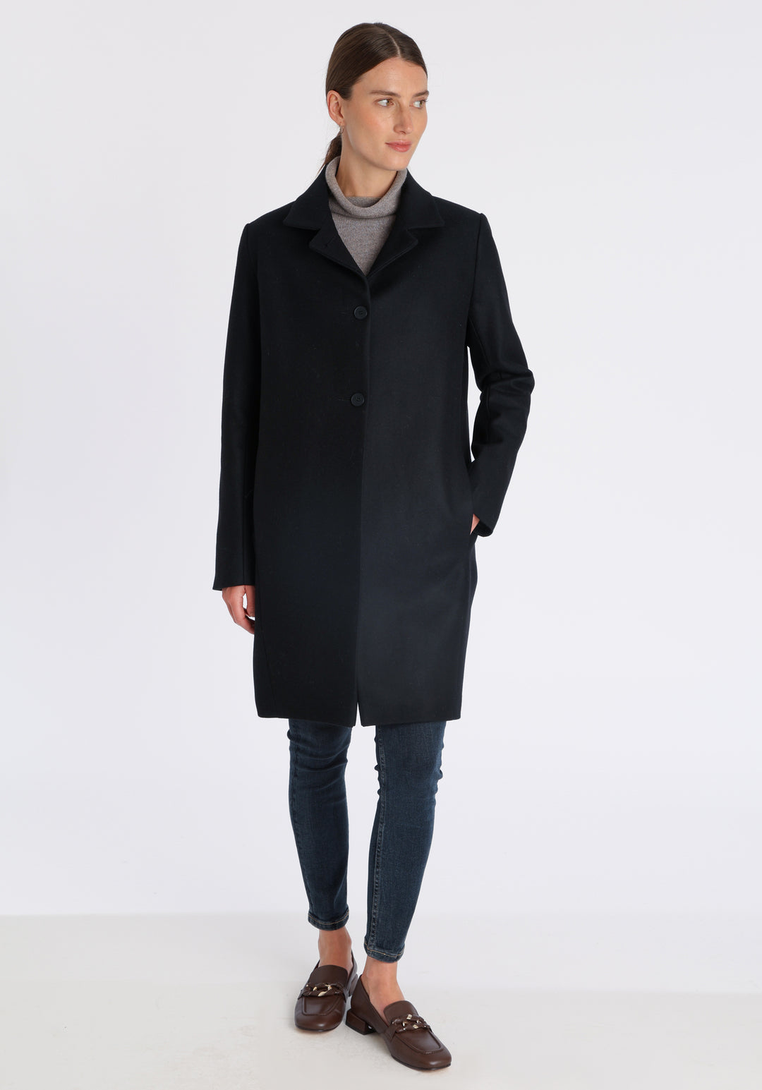 Model wearing the Jackson coat in black cashmere blend, a staple cocoon-shaped style with tailored shoulders and a clean, streamlined silhouette.