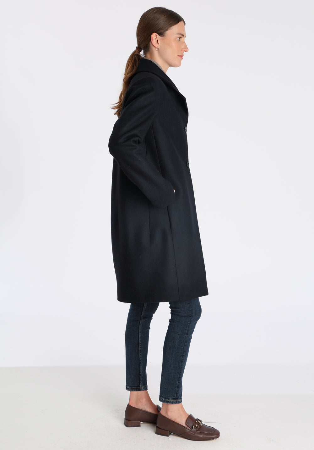 Model wearing the Jackson coat in black cashmere blend, a staple cocoon-shaped style with tailored shoulders and a clean, streamlined silhouette.