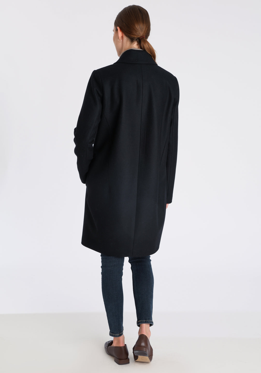 Model wearing the Jackson coat in black cashmere blend, a staple cocoon-shaped style with tailored shoulders and a clean, streamlined silhouette.