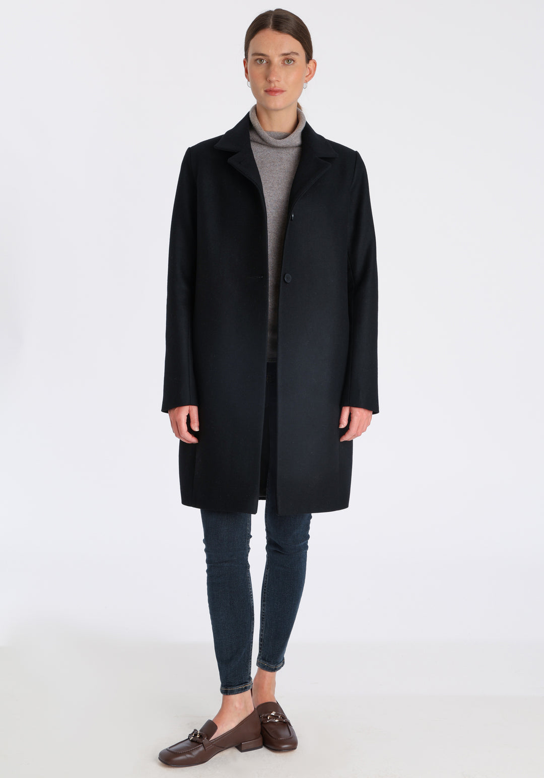 Model wearing the Jackson coat in black cashmere blend, a staple cocoon-shaped style with tailored shoulders and a clean, streamlined silhouette.