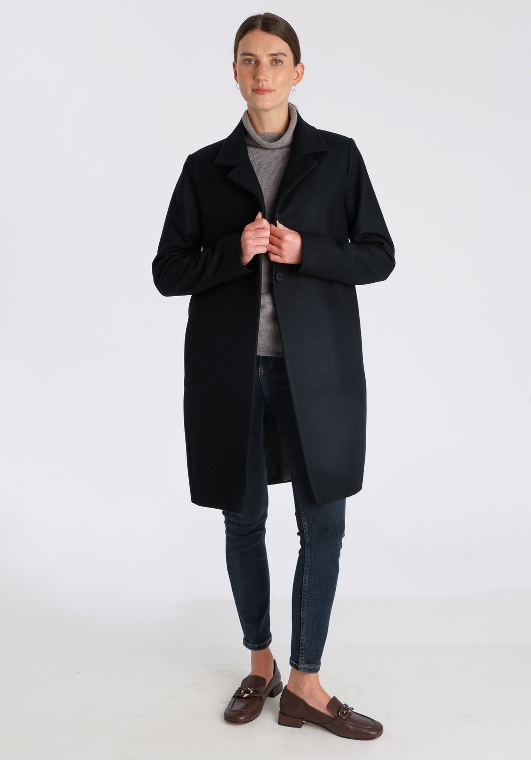 Model wearing the Jackson coat in black cashmere blend, a staple cocoon-shaped style with tailored shoulders and a clean, streamlined silhouette.