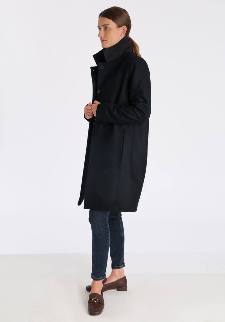 Model wearing the Jackson coat in black cashmere blend, a staple cocoon-shaped style with tailored shoulders and a clean, streamlined silhouette.