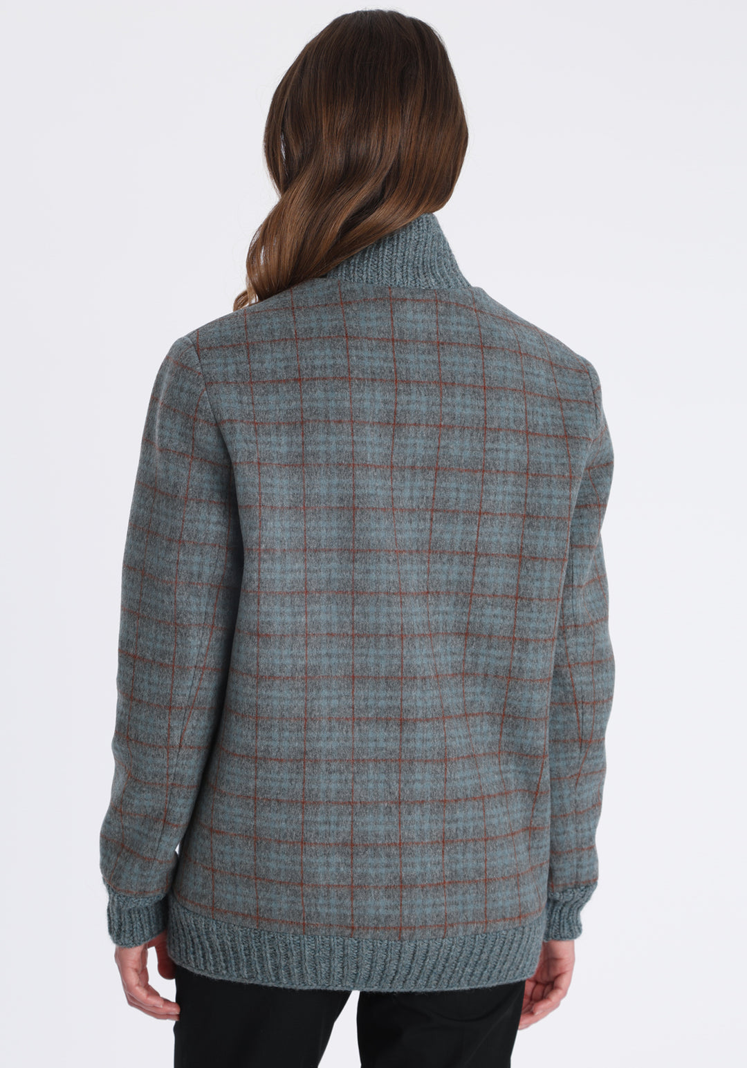 Model wearing the Jeffy jacket in silver blue and rust check merino wool, a baseball-inspired style with curved pocket flaps, front button fastenings, and ribbed knit trim, cut in a streamlined silhouette.