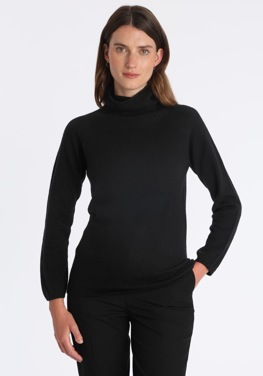 Model wearing the fine-knit cashmere jumper in black, a slim fit style with a draped high neck, designed for layering and year-round wear.