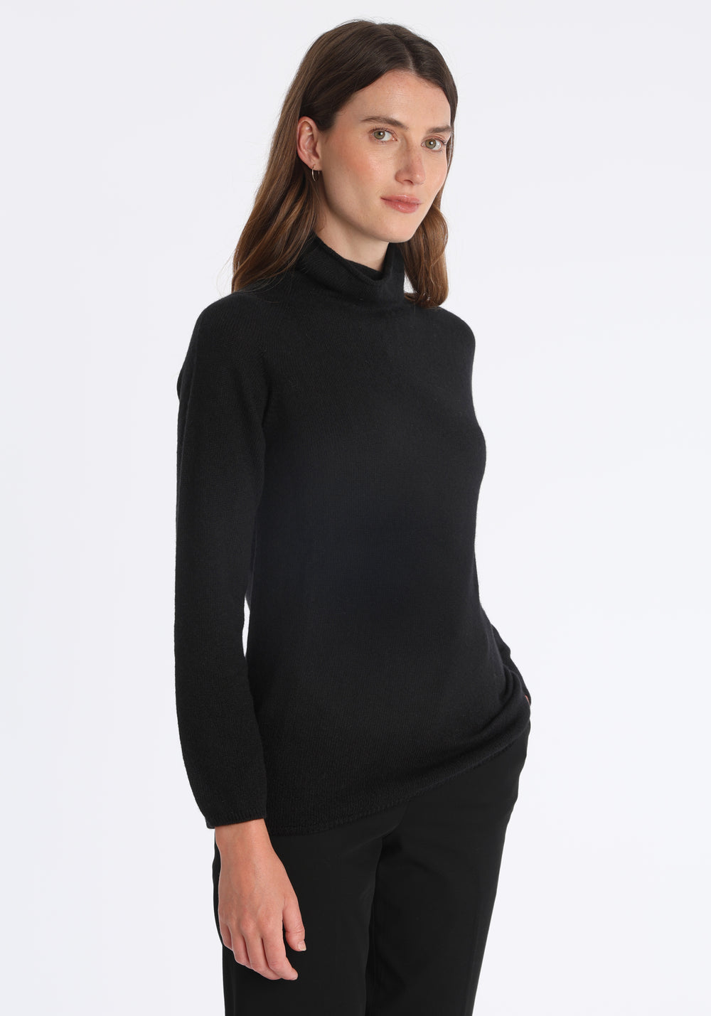 Model wearing the fine-knit cashmere jumper in black, a slim fit style with a draped high neck, designed for layering and year-round wear.