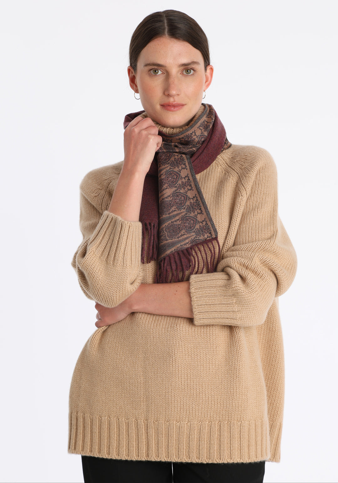 Model wearing the chunky roll neck jumper in dune Scottish cashmere—a one-size knit with dropped shoulders, ribbed trims, and a softly structured silhouette