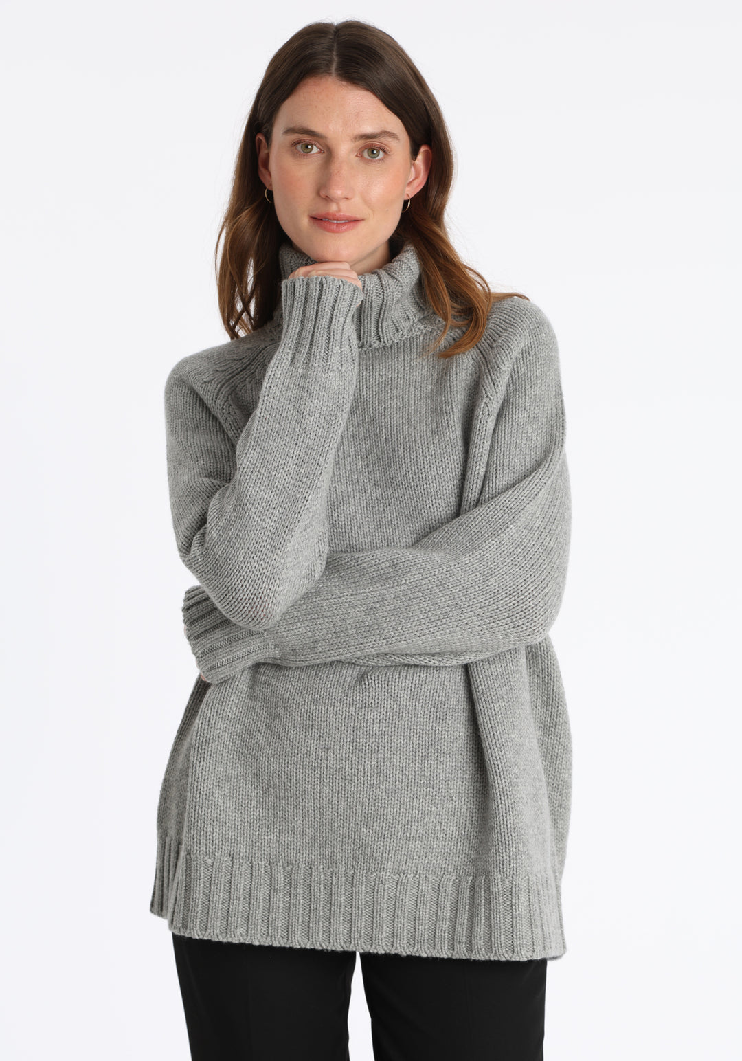 Model wearing the chunky roll neck jumper in grey marl Scottish cashmere—a one-size knit with dropped shoulders, ribbed trims, and a softly structured silhouette.
