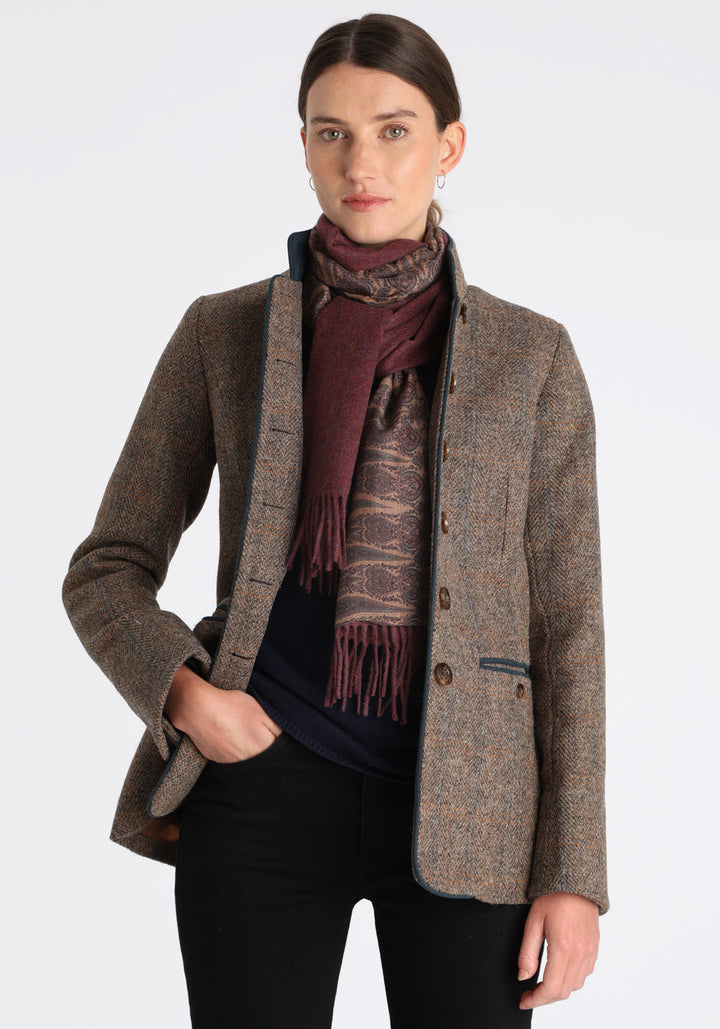 Model wearing the shiraz marl cashmere scarf backed with antique camel paisley printed silk, styled with the Patmos jacket in clay tweed.