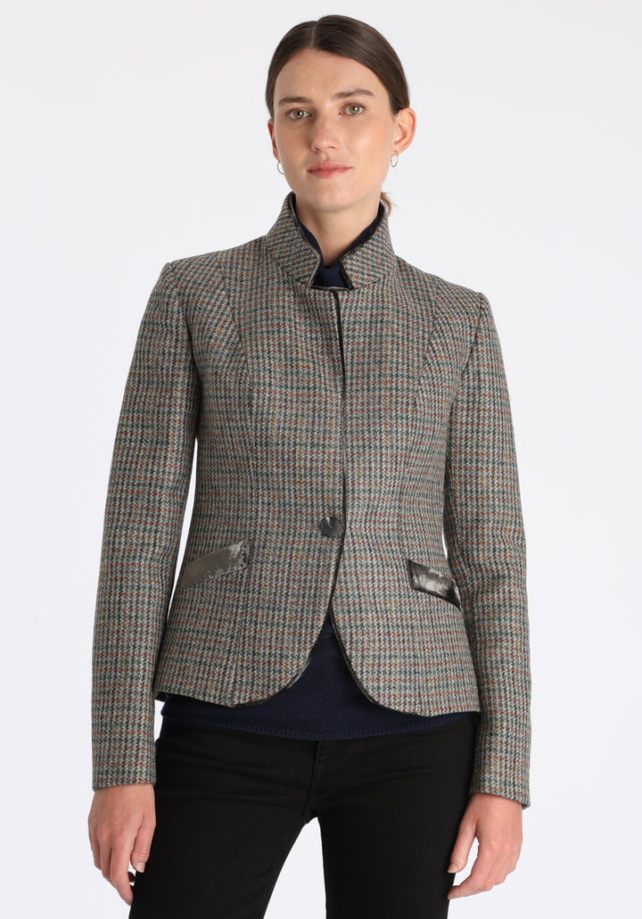 Model wearing the Tallulah jacket in autumnal cinder check with silk velvet trim, a tailored style with a single button fastening and a collar that can be worn turned up or down.