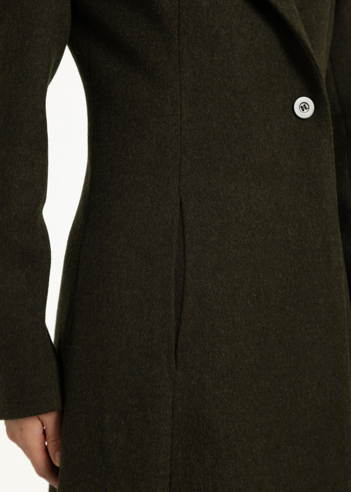 Close up of a dark olive wool coat with a singular button fastening.