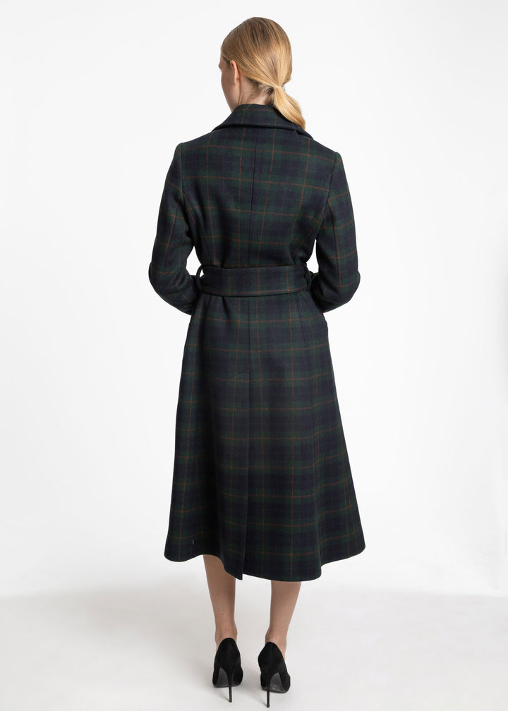 Back view of a woman wearing a navy and dark green plaid belted wool coat.