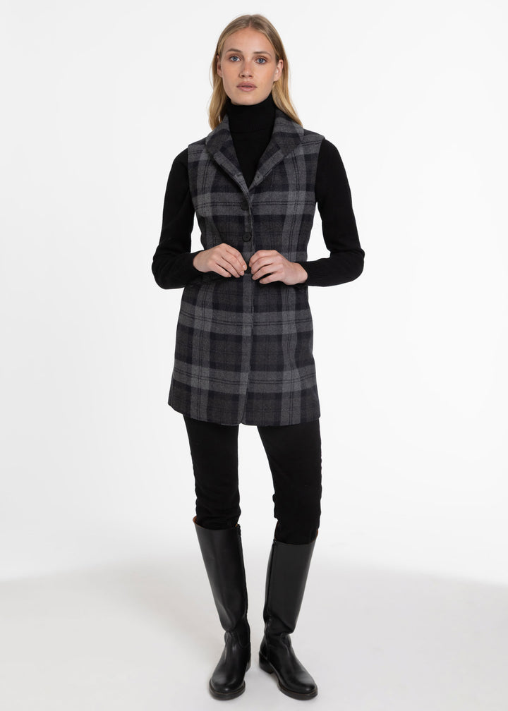 Woman wearing black and grey check wool sleeveless waistcoat.