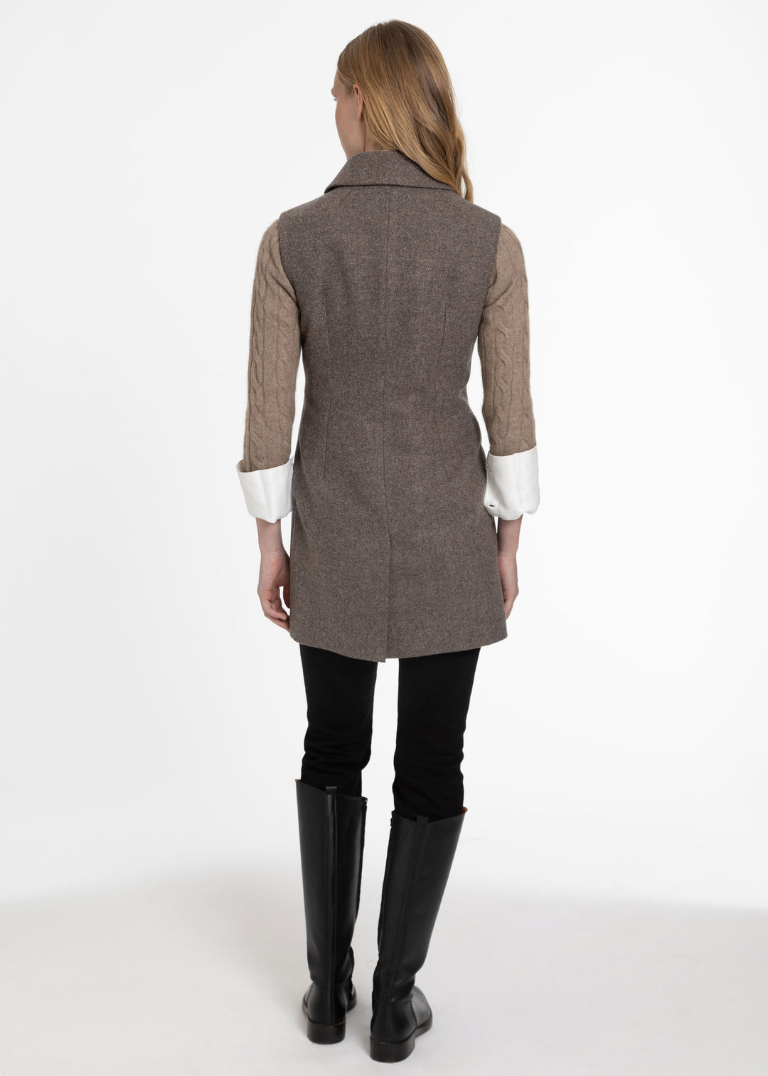 Back of woman wearing a taupey brown sleevless waistcoat.