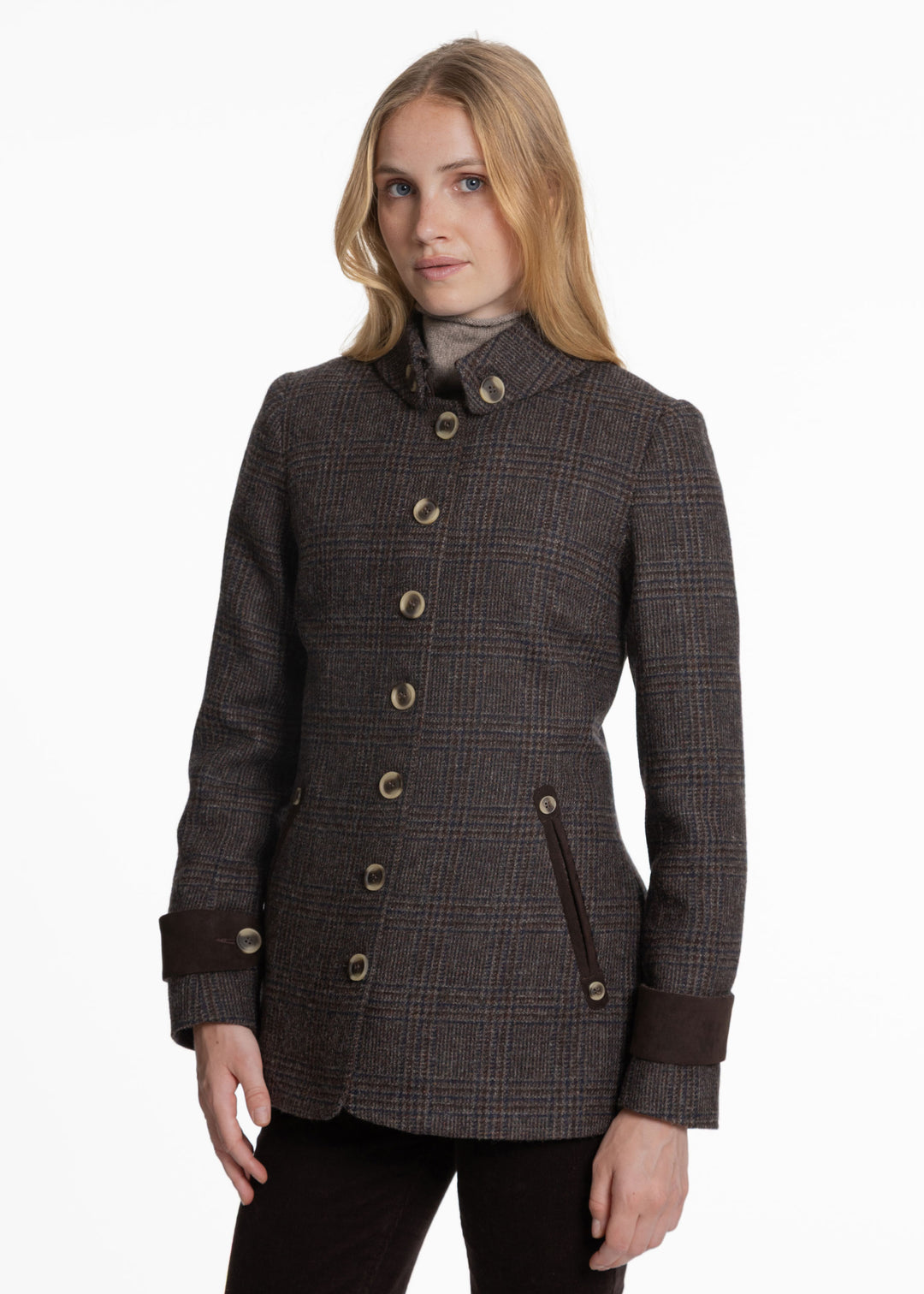 A woman modeling a dark brown and black plaid wool coat with beige buttons and dark brown buttoned cuffs, set against a plain white studio background.
