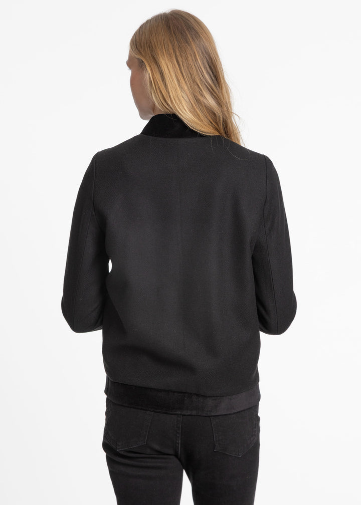 Back of a woman wearing a black jacket