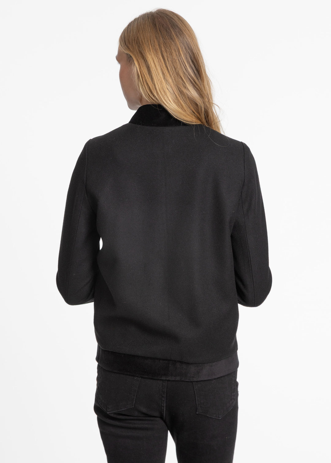 Back of a woman wearing a black jacket