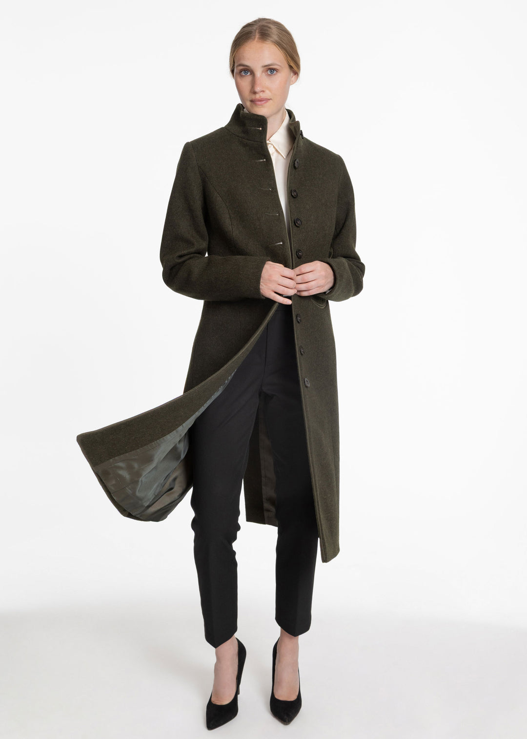 Woman wearing an olive green coat that swings open to show a green lining