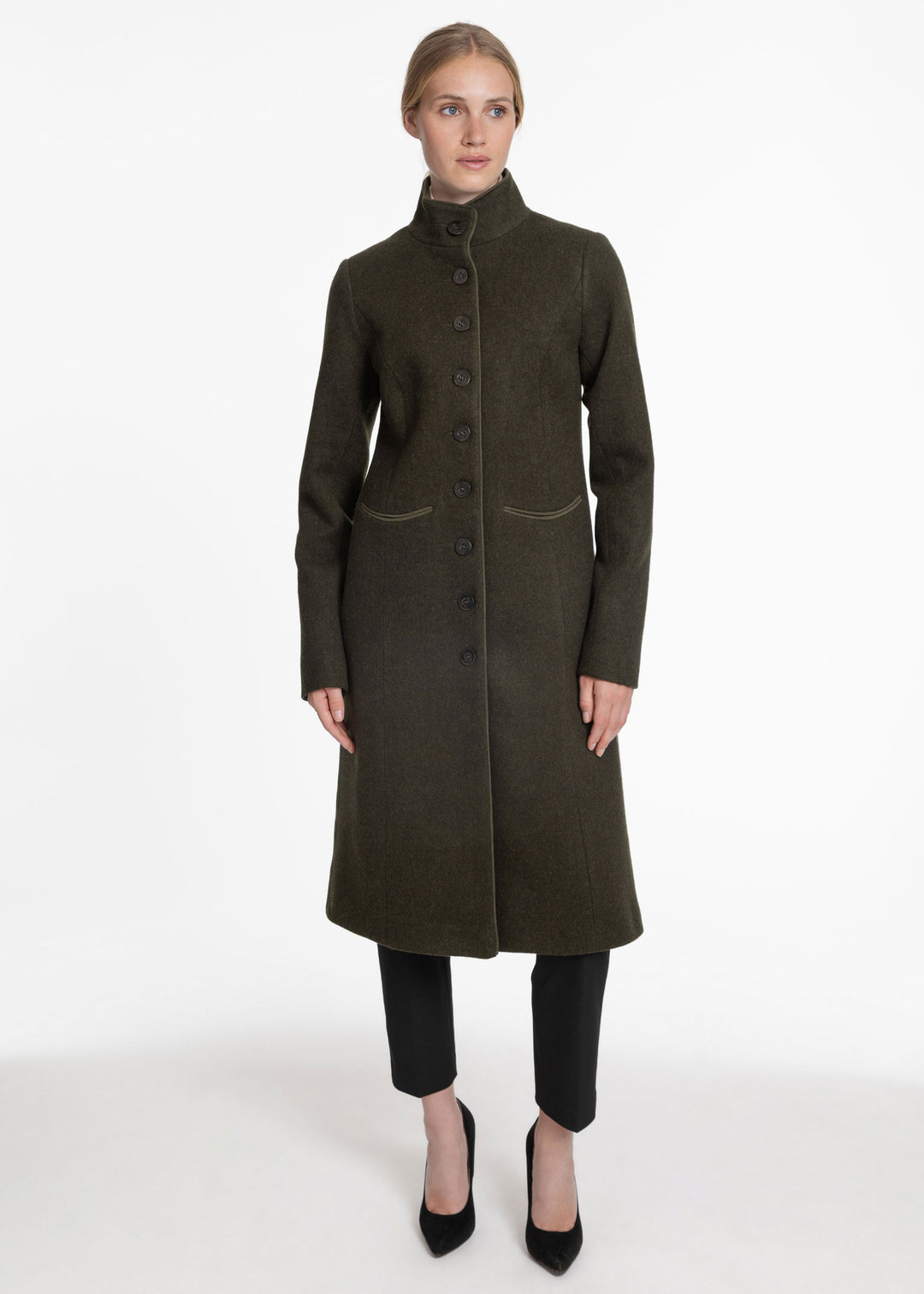 Woman wearing an olive green wool coat with buttons down the front.