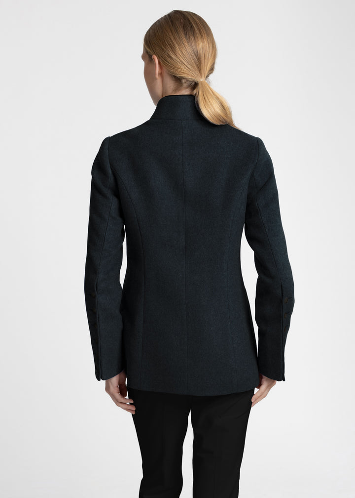 Back view of a woman wearing a dark green jacket.