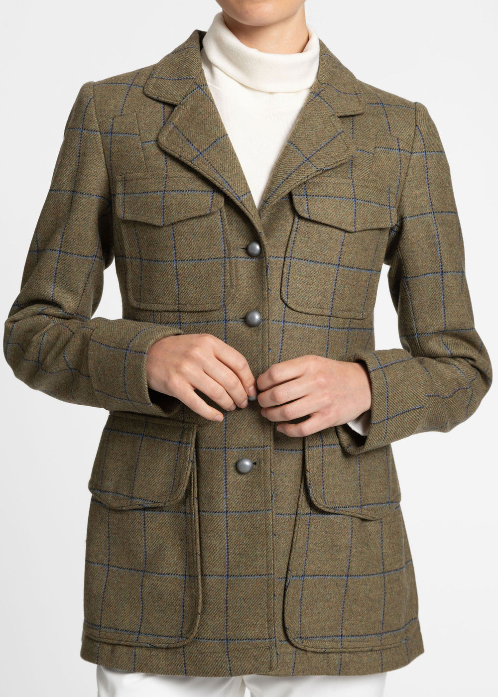 Close up of a green utility jacket with blue check and silver metal buttons.