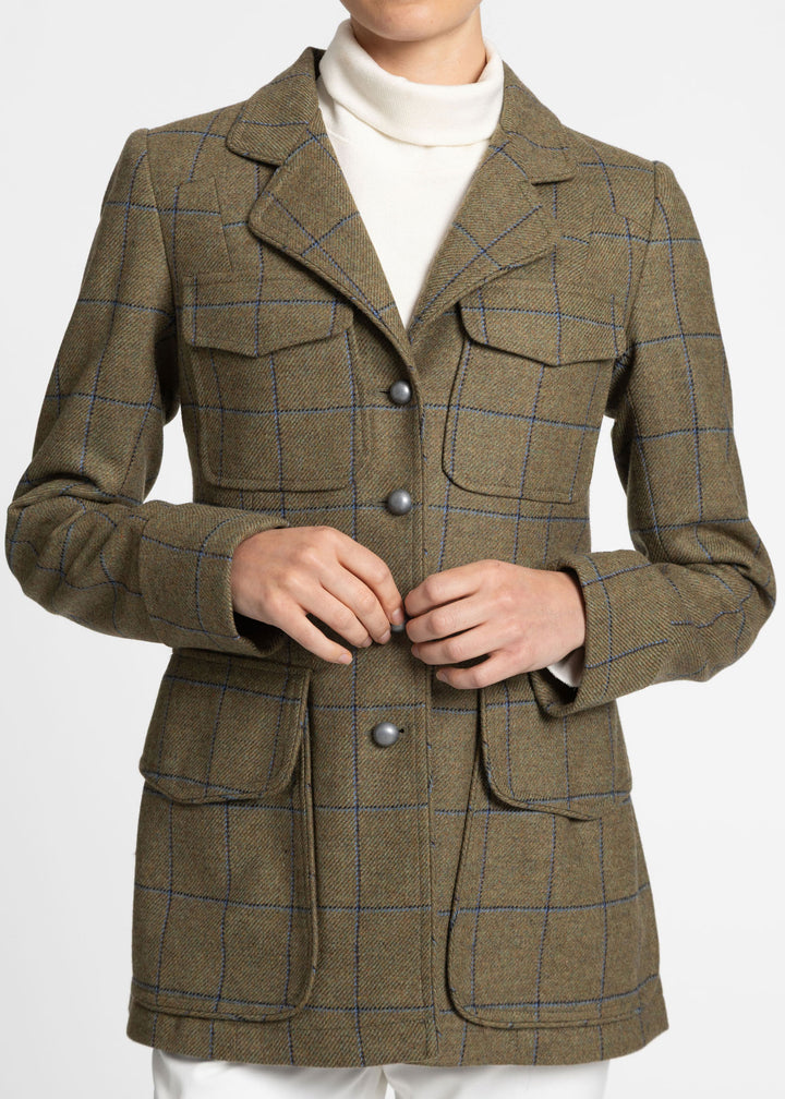 Close up of a green utility jacket with blue check and silver metal buttons.