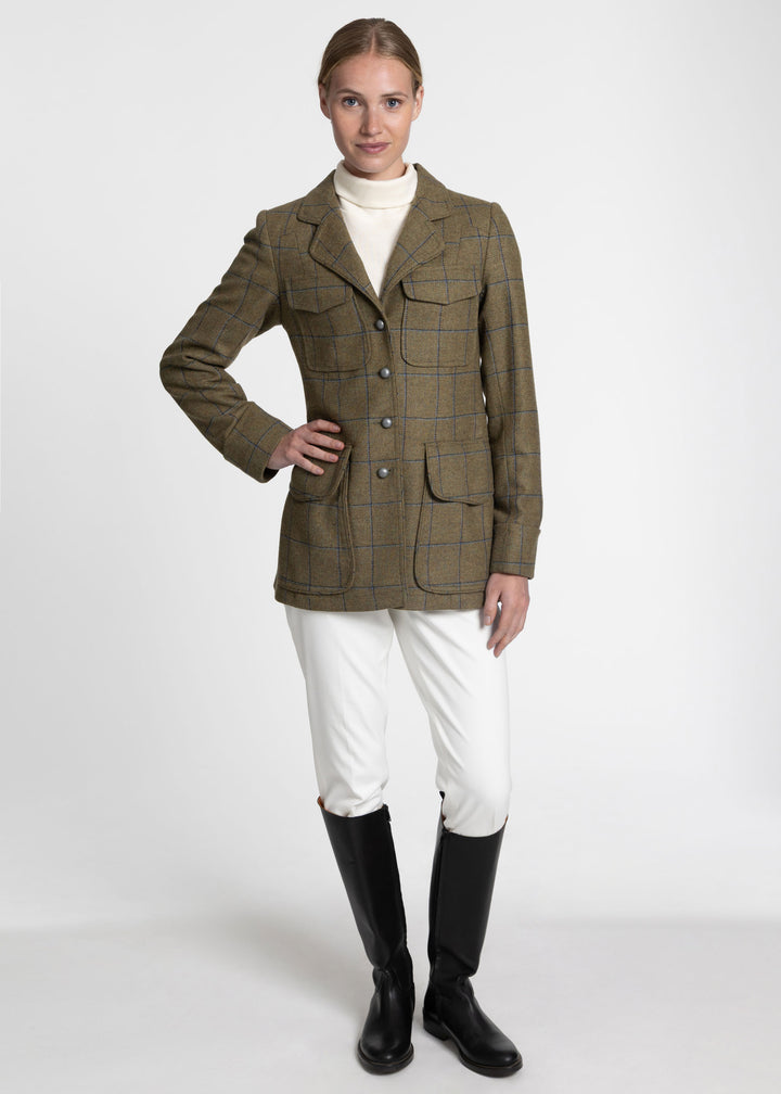 Woman wearing a green utility jacket with blue check.