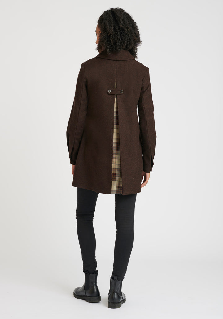 Back of a person wearing a brown coat with a plaid pattern inside the vent on a white background