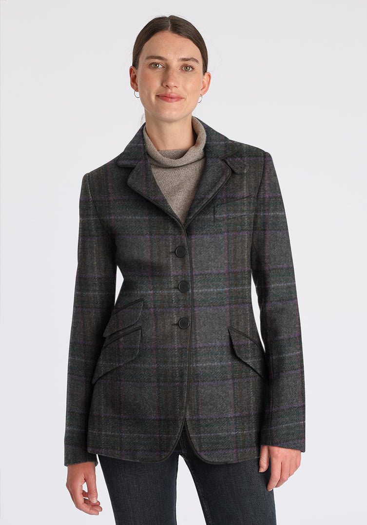 Woman wearing a purple and gray plaid jacket on a white background