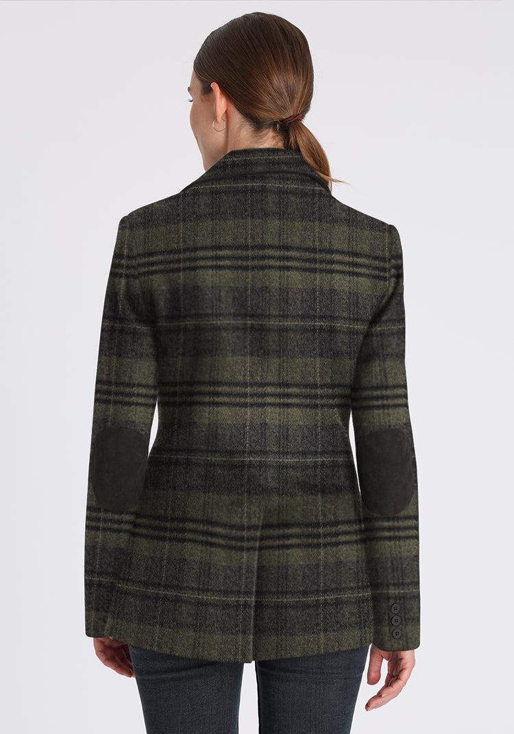 Green and grey checked jacket worn by a person on a white background