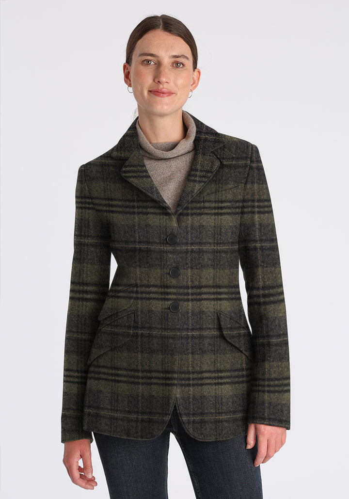 Woman wearing a green and grey checked jacket on a white background