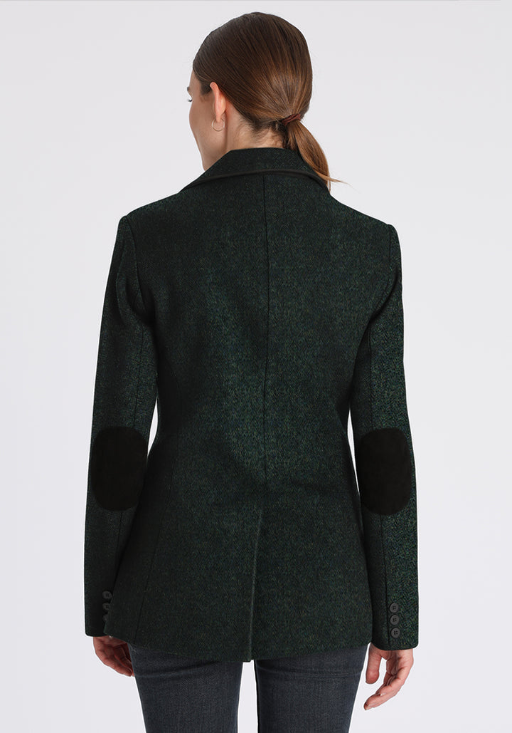 Back of woman wearing a green jacket with black elbow patches