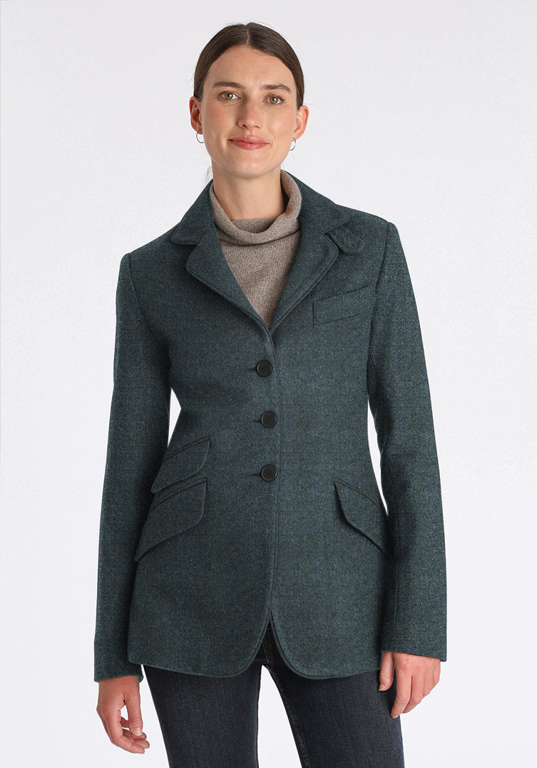 Woman wearing a teal wool jacket with slate buttons