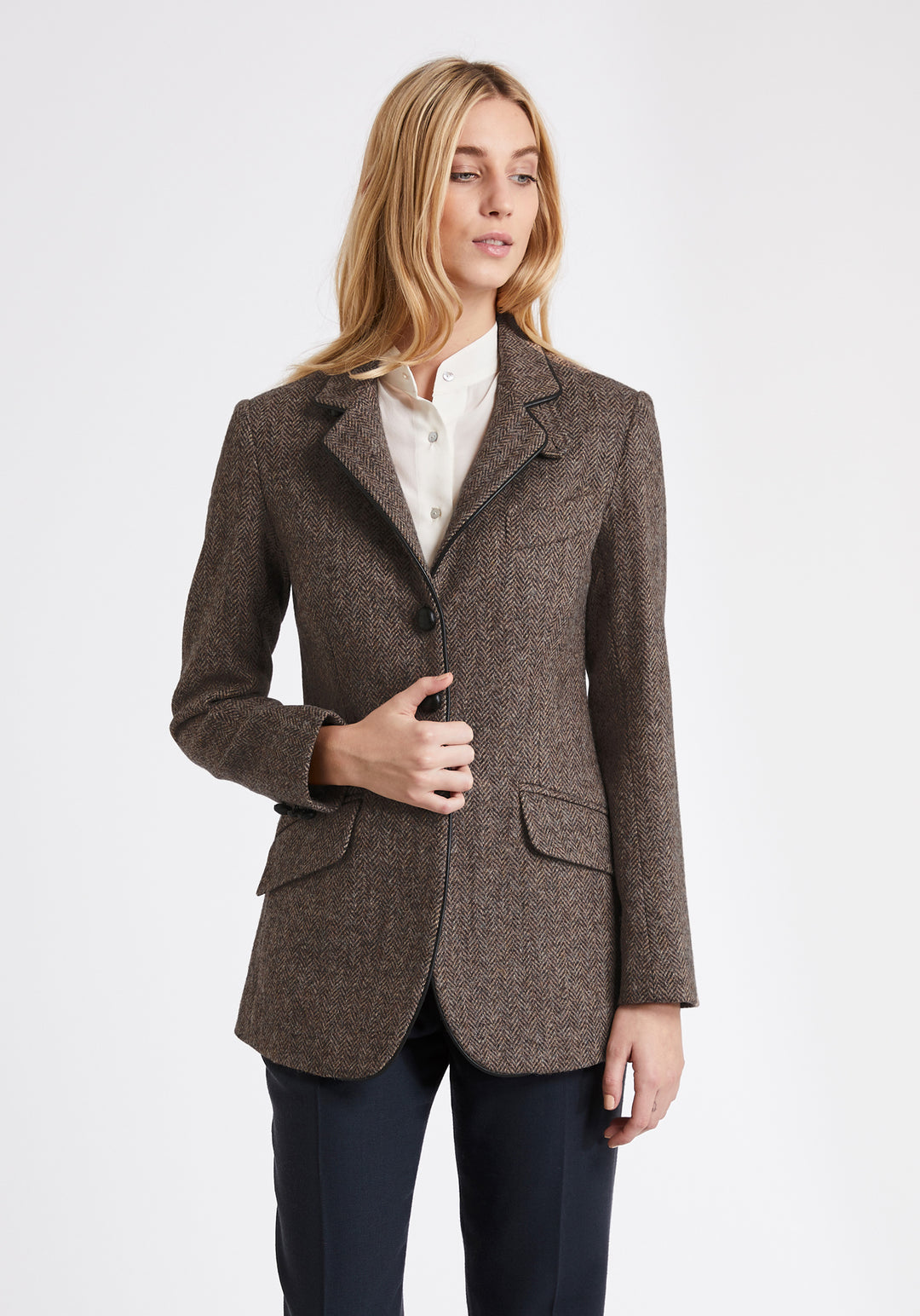 A model wears the Cass jacket, a relaxed boyfriend-style jacket with subtle equestrian inspired detailing.