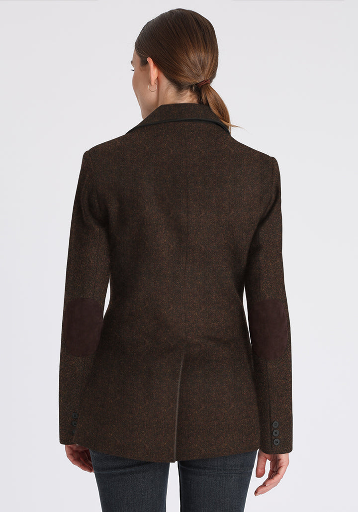 Brown wool jacket with brown elbow patches worn by a person on a white background