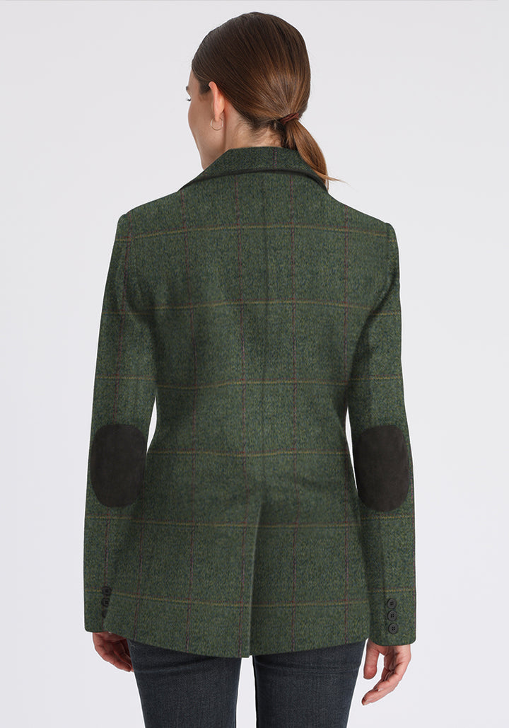 Back of woman wearing green wool jacket with faint yellow and red overcheck with dark green elbow patches