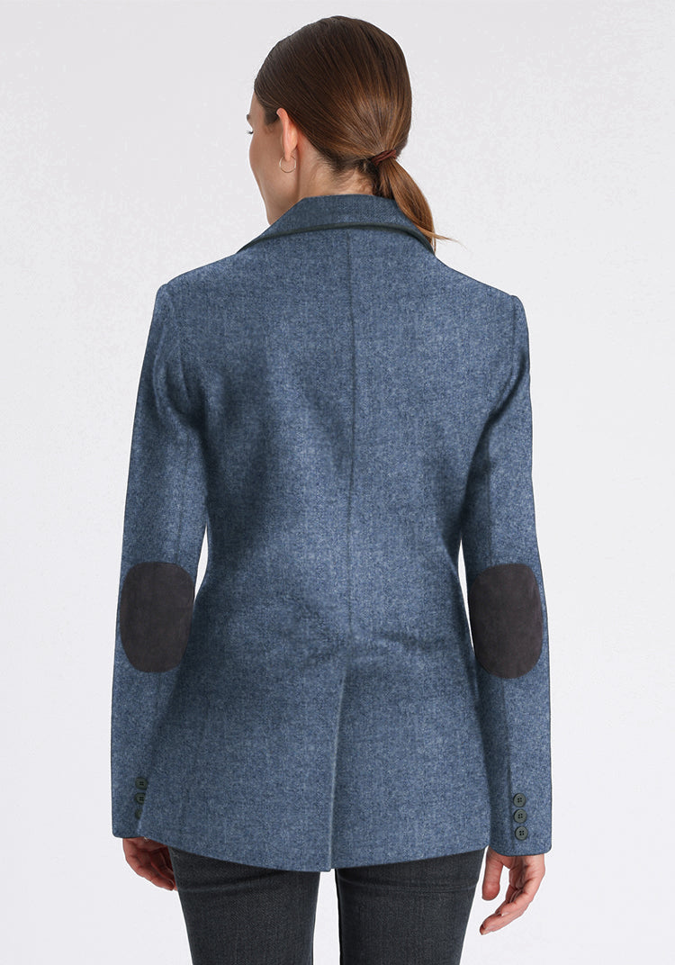 Back of woman wearing blue wool jacket with chocolate brown elbow patches