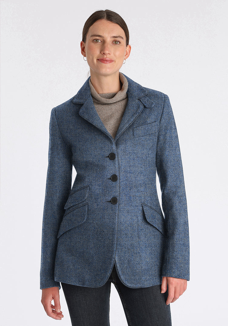 Woman wearing blue wool jacket with slate buttons down the front