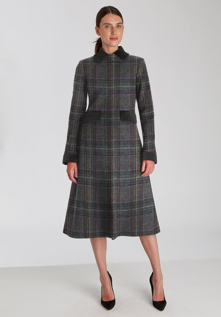 Woman wearing long purple check wool coat with contrasting dark grey pocket flaps, collar, and cuffs