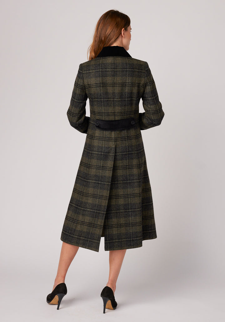 Back of woman wearing grey and green check wool coat with black cotton velvet on the collar and back belt detail