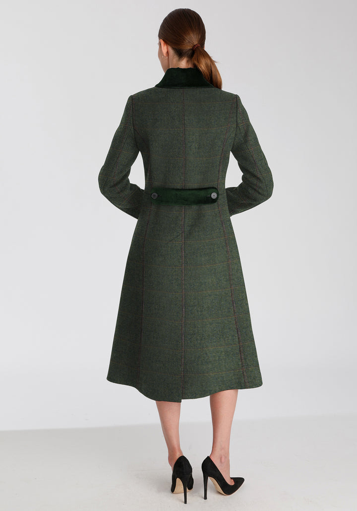 Back of woman wearing sage green wool coat with a faint yellow and red overcheck. Dark green detailing on the collar and back belt
