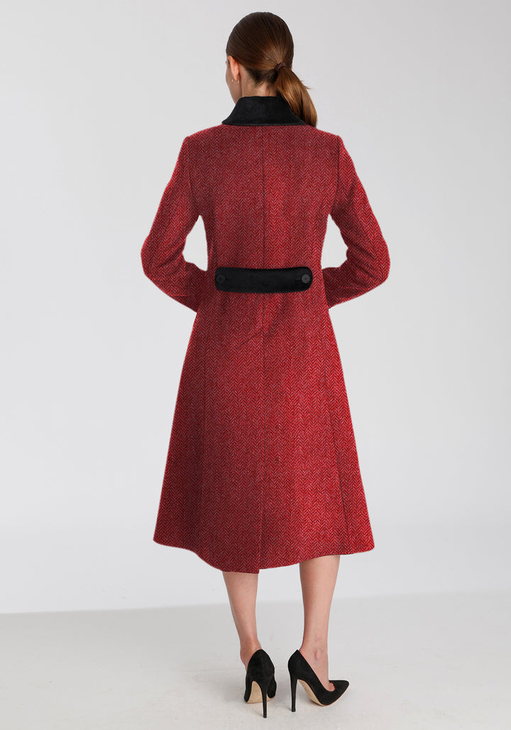 Back of woman wearing red and pink herringbone coat with black detailing on the collar and back belt