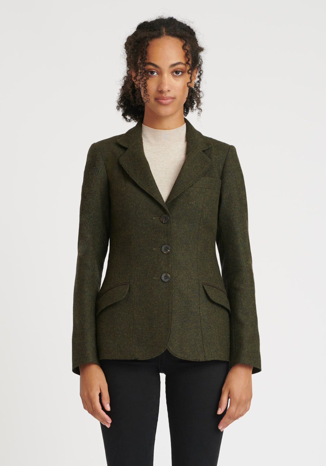 Woman wearing a green wool jacket with chocolate brown buttons